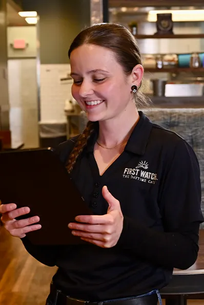 A restaurant manager reviewing PreciTaste on a tablet